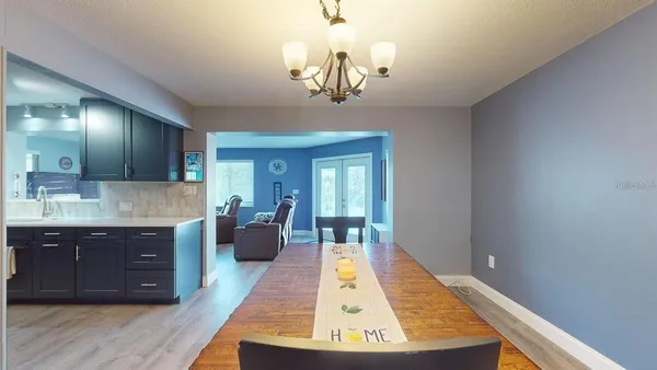 a living room with furniture a window and a flat screen tv