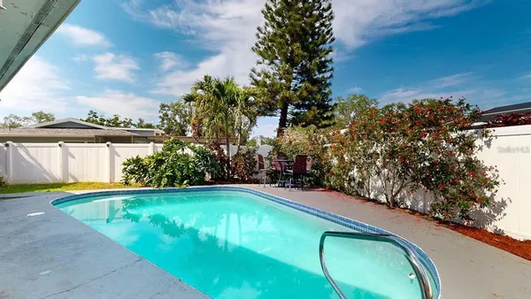 a view of a swimming pool with an outdoor seating