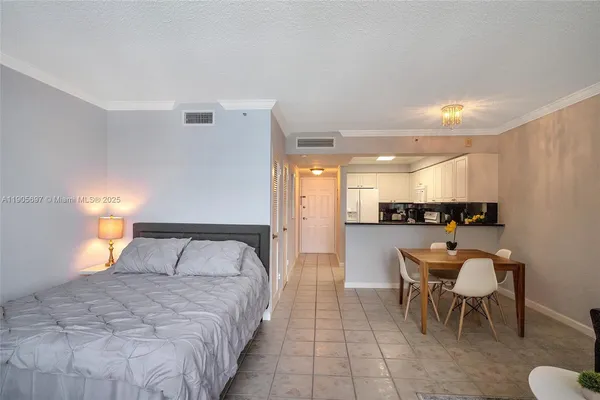 a bedroom with a bed and mirror