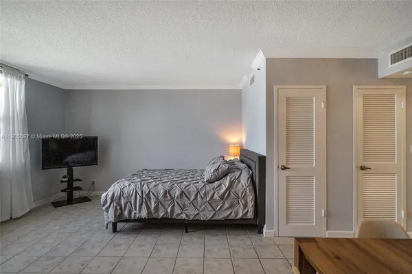 a bedroom with a bed and a chair in it