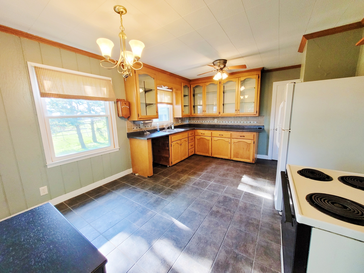 11393 Ward Road Morrison, IL 61270 - Photo 10 of 22 a kitchen with granite countertop a stove a sink a window and stainless steel appliances