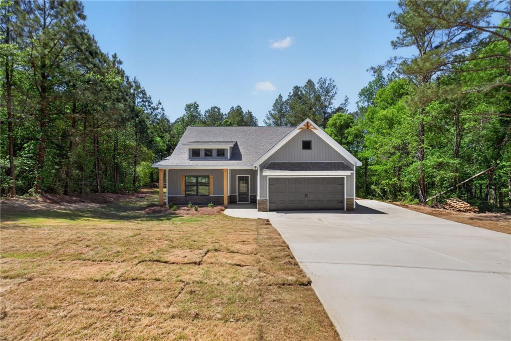 57 Oak Grove Road Taylorsville, GA 30178 - Photo 2 of 42 a front view of a house with a yard and garage