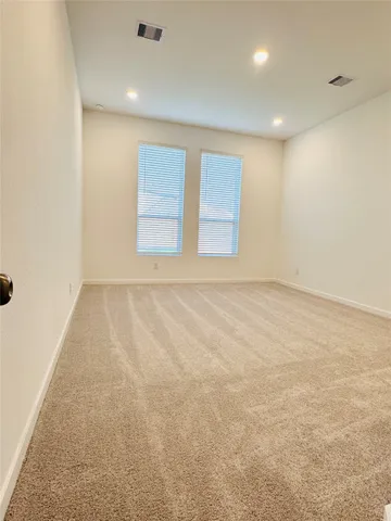 a view of a living room with furniture and wooden floor
