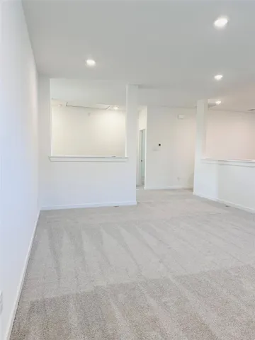 an empty room with closet and windows