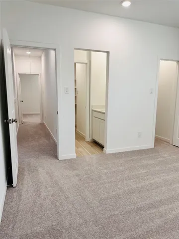 a kitchen with stainless steel appliances kitchen island granite countertop a table chairs in it and wooden floors