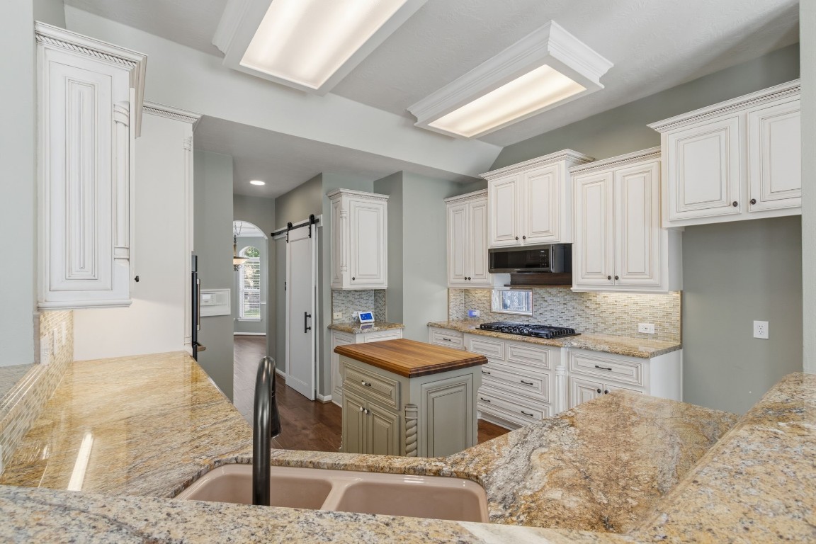 3403 Marywood Drive Spring, TX 77388 - Photo 15 of 50 a kitchen with stainless steel appliances granite countertop a sink stove and refrigerator