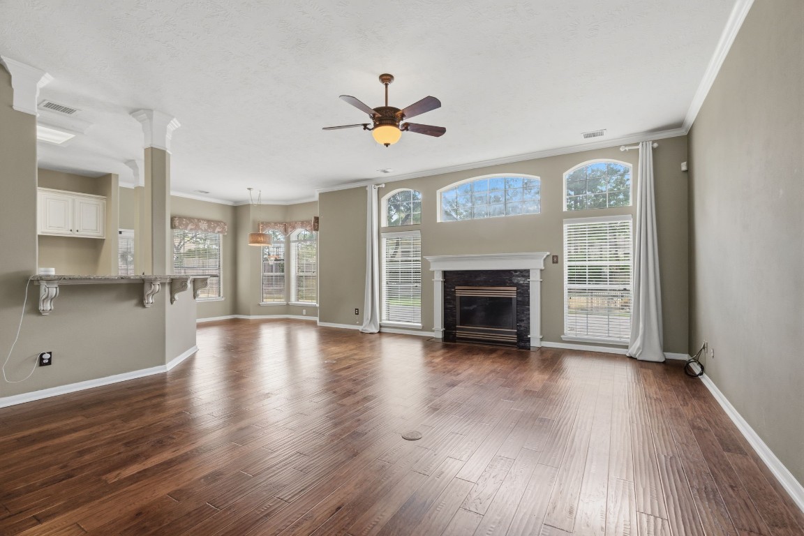 3403 Marywood Drive Spring, TX 77388 - Photo 21 of 50 an empty room with wooden floor fireplace and windows