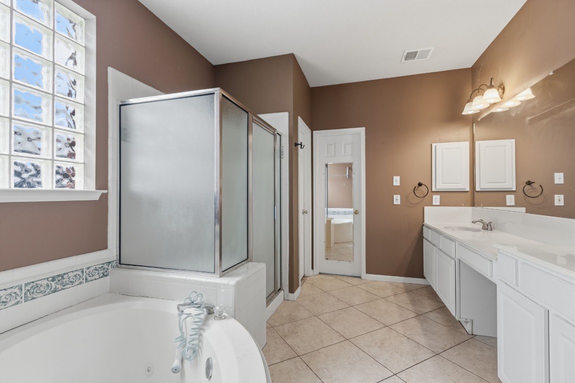 3403 Marywood Drive Spring, TX 77388 - Photo 23 of 50 a bathroom with a bathtub and a shower