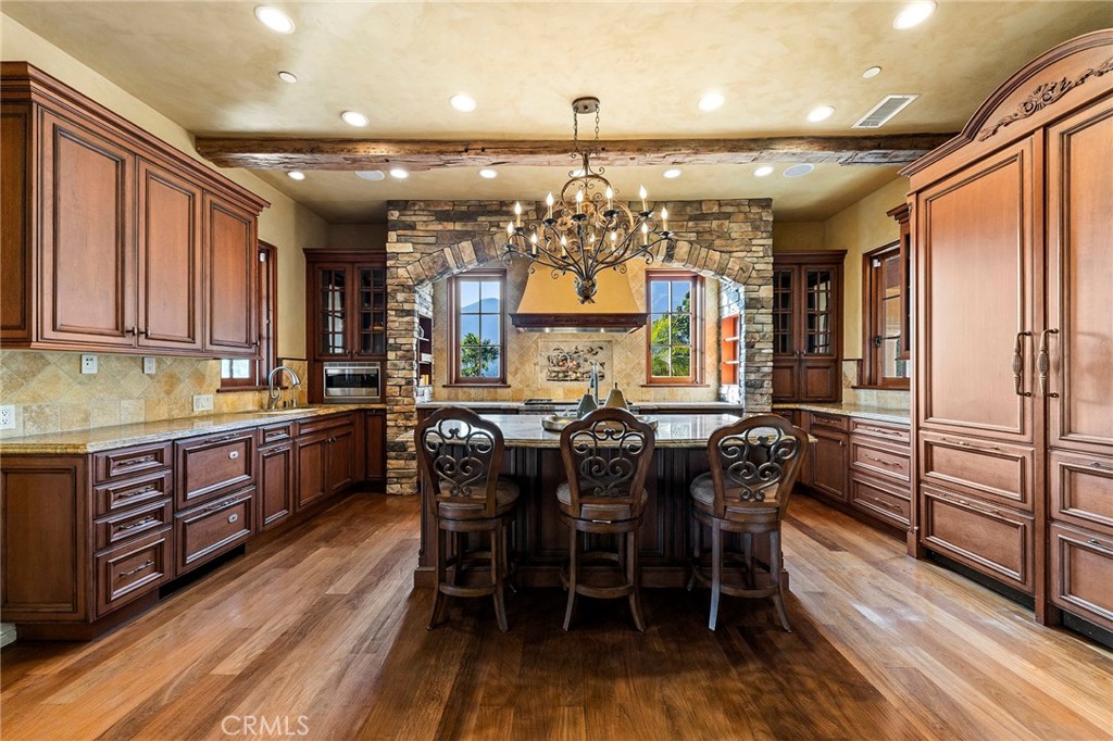 367 Monterey Pines Drive Arcadia, CA 91006 - Photo 16 of 74 a kitchen with stainless steel appliances kitchen island granite countertop a table chairs and a refrigerator