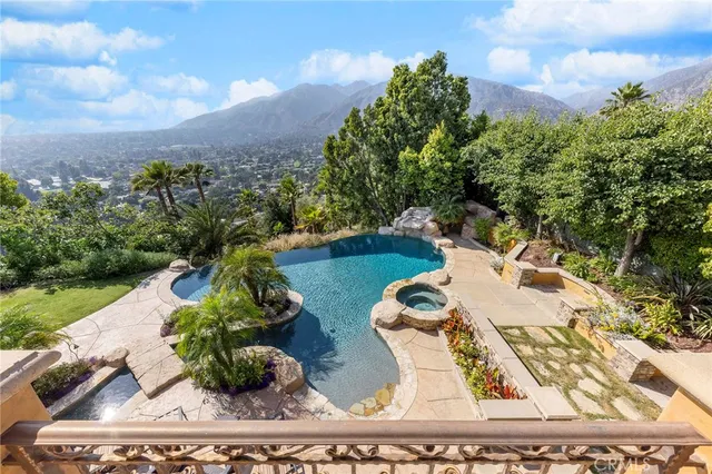 a front view of a house with swimming pool having outdoor seating