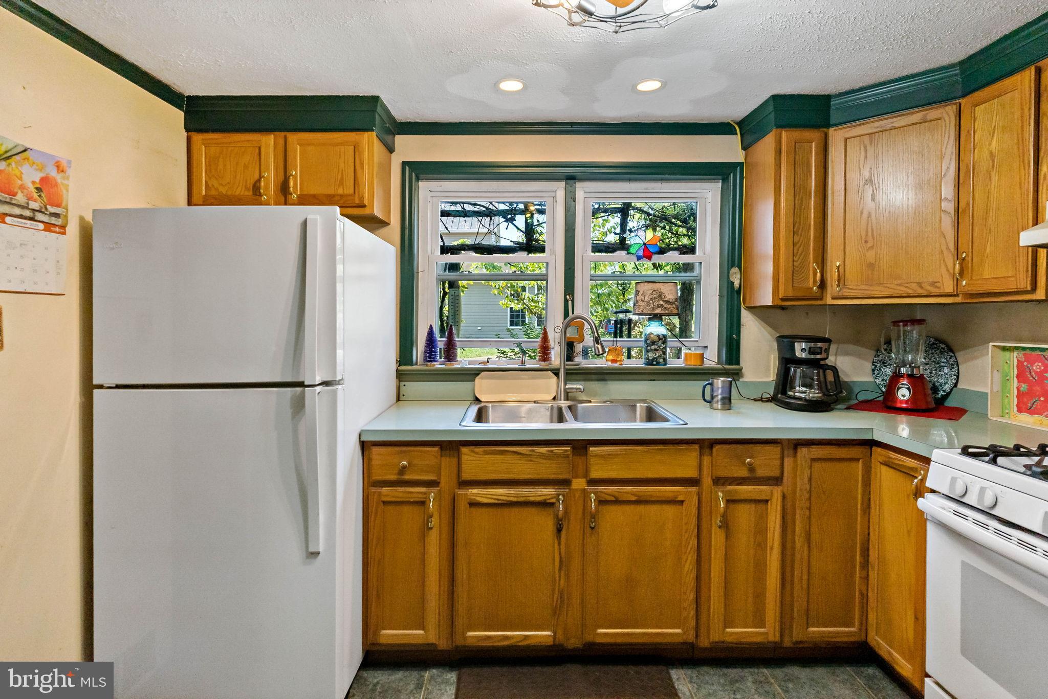 9157 Williamsport Pike Falling Waters, WV 25419 - Photo 21 of 51 a kitchen with a refrigerator a sink and a window