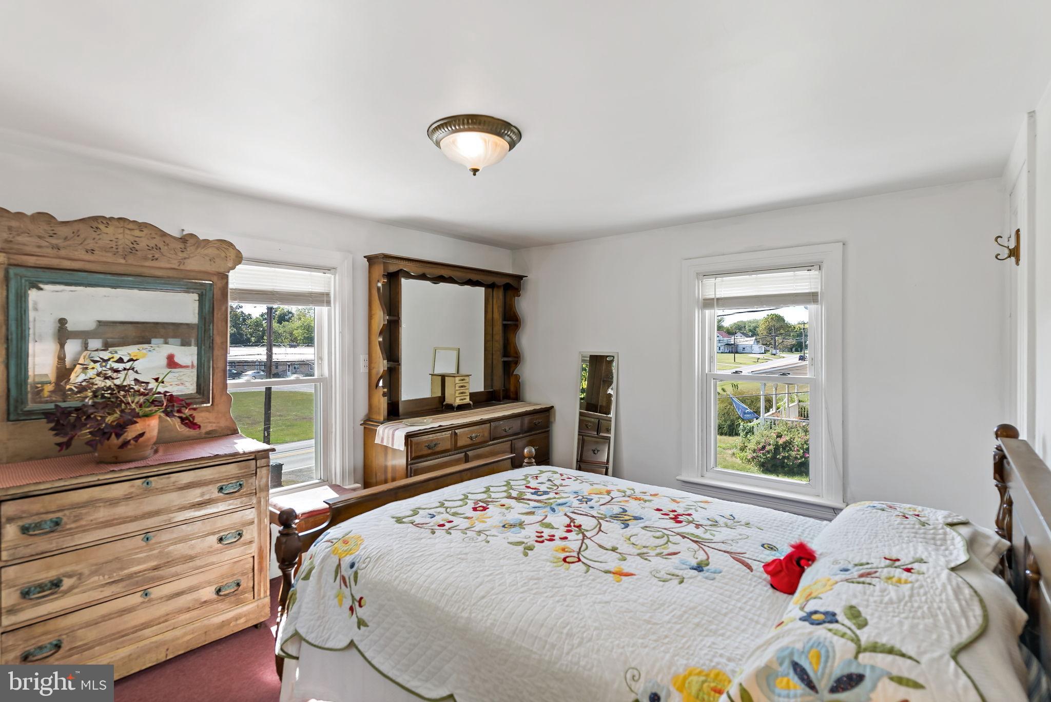 9157 Williamsport Pike Falling Waters, WV 25419 - Photo 10 of 51 a bedroom with a bed and large windows
