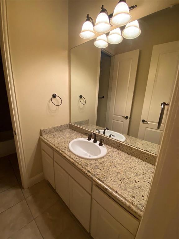 2222 Kirby Street Dallas, TX 75204 - Photo 5 of 25 Bathroom vanity featuring a light speckled countertop, undermount sink, and dark bronze faucet