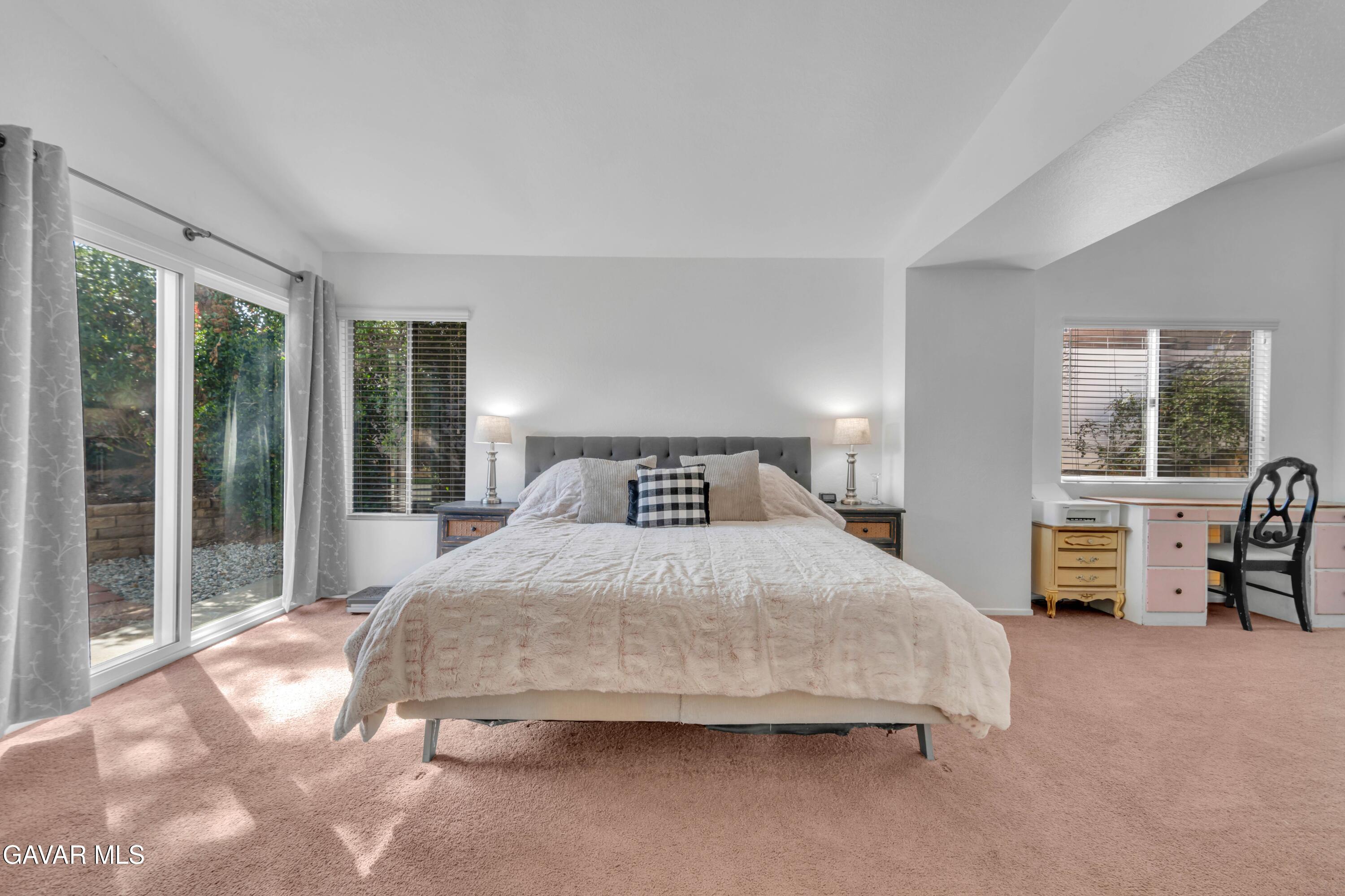 3046 Hampton Road Palmdale, CA 93551 - Photo 11 of 27 a bedroom with a large bed and two large window