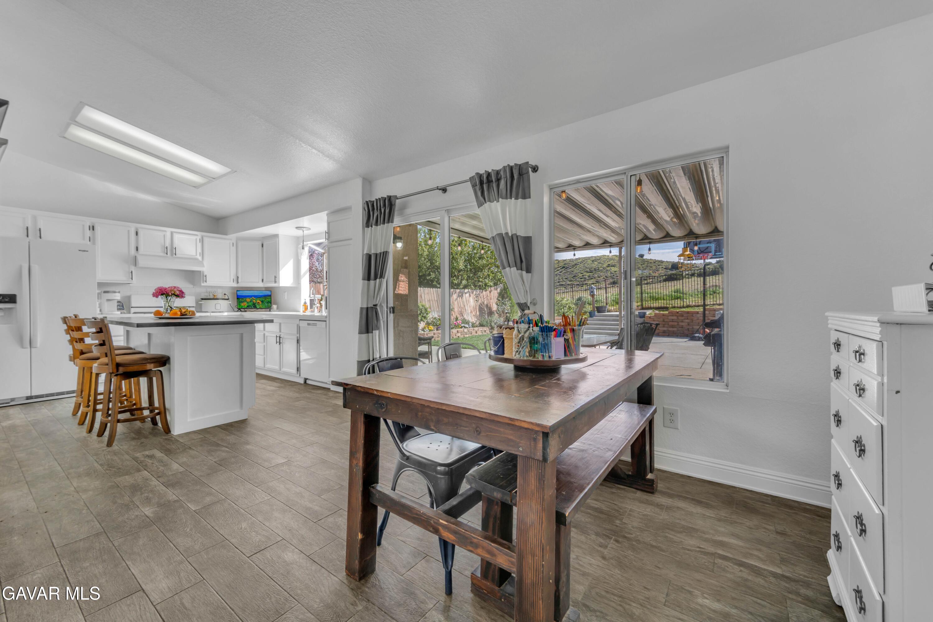 3046 Hampton Road Palmdale, CA 93551 - Photo 15 of 27 a view of a dining room with furniture and a table