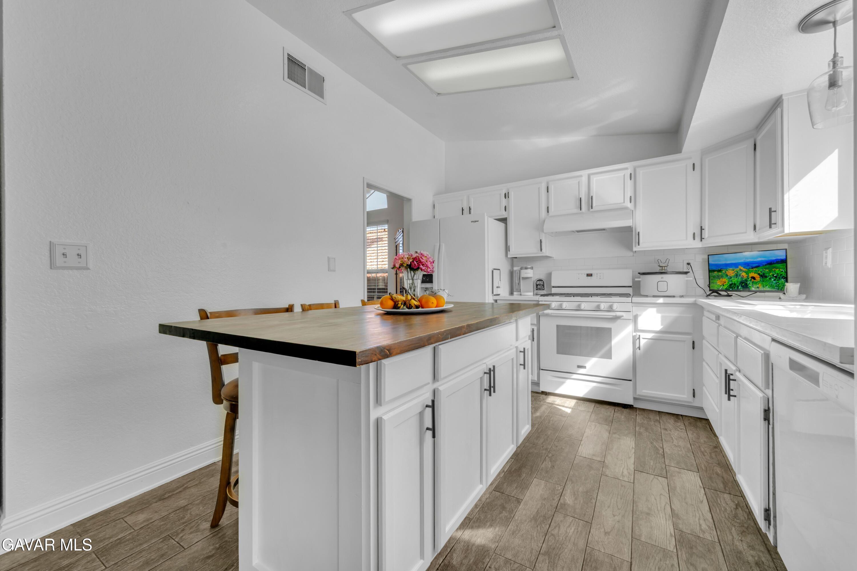 3046 Hampton Road Palmdale, CA 93551 - Photo 16 of 27 a kitchen with cabinets a sink and appliances