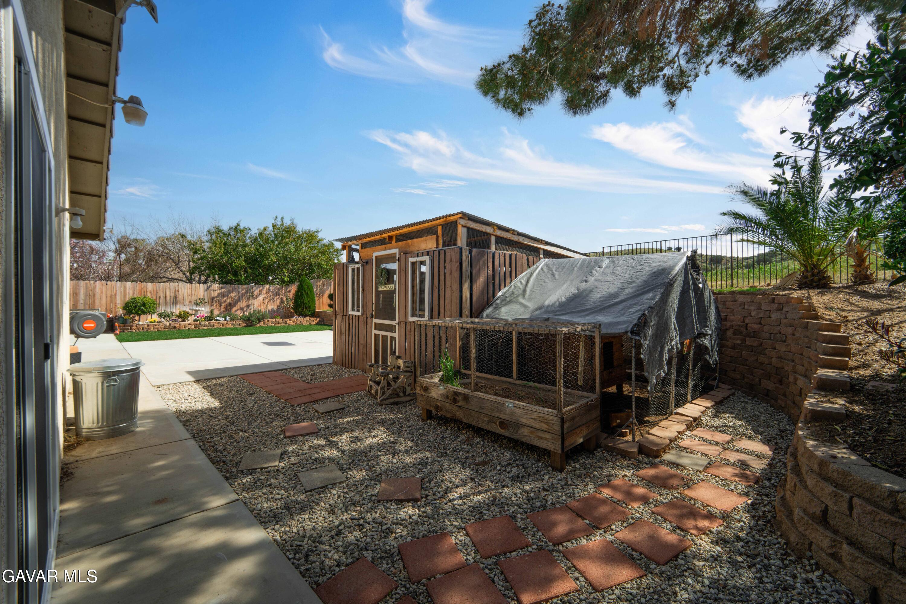 3046 Hampton Road Palmdale, CA 93551 - Photo 23 of 27 a view of a small house in the yard