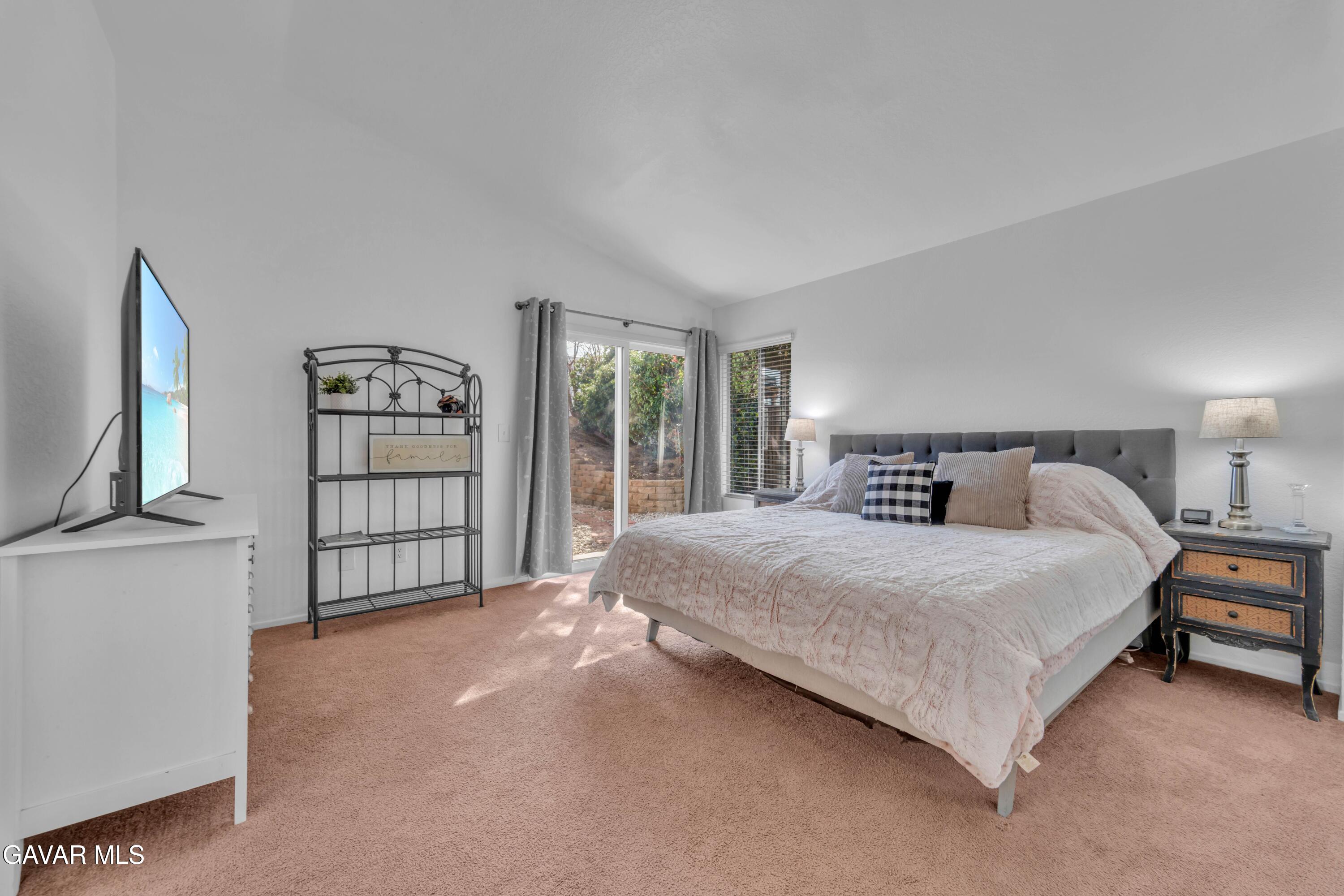 3046 Hampton Road Palmdale, CA 93551 - Photo 4 of 27 a spacious bedroom with a bed and a flat screen tv