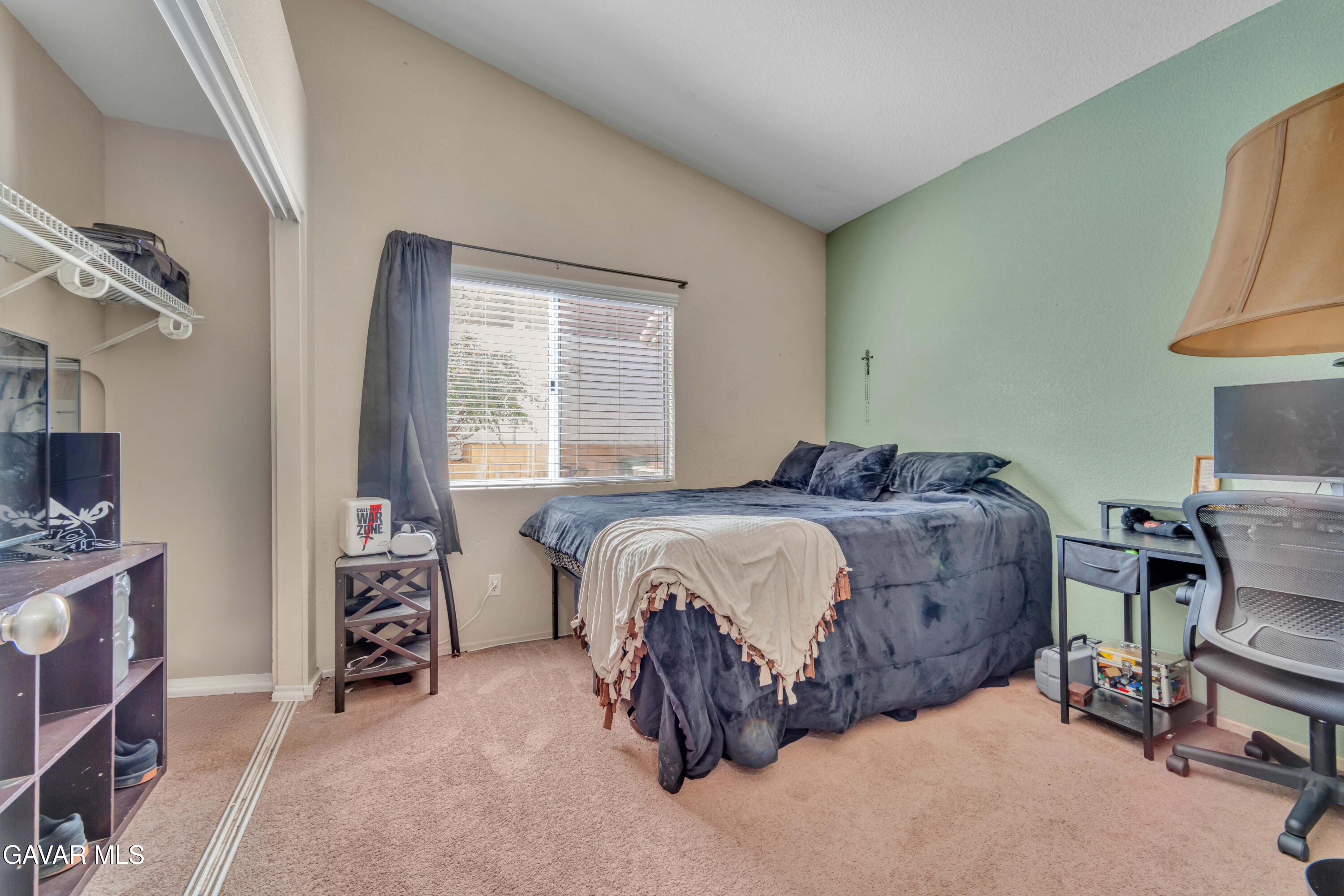 3046 Hampton Road Palmdale, CA 93551 - Photo 8 of 27 a bedroom with a bed and a chair