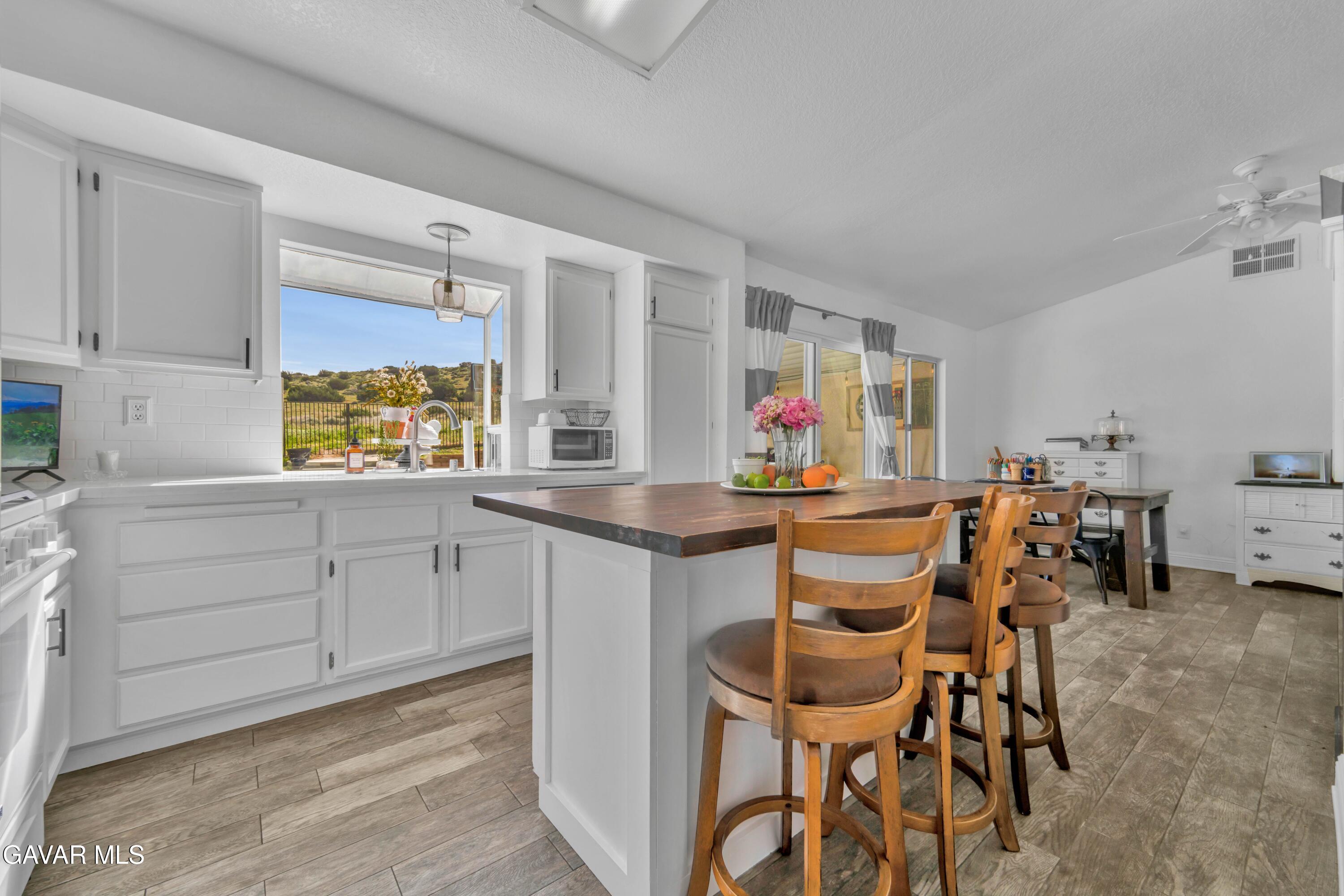 3046 Hampton Road Palmdale, CA 93551 - Photo 9 of 27 a view of a kitchen and dining room