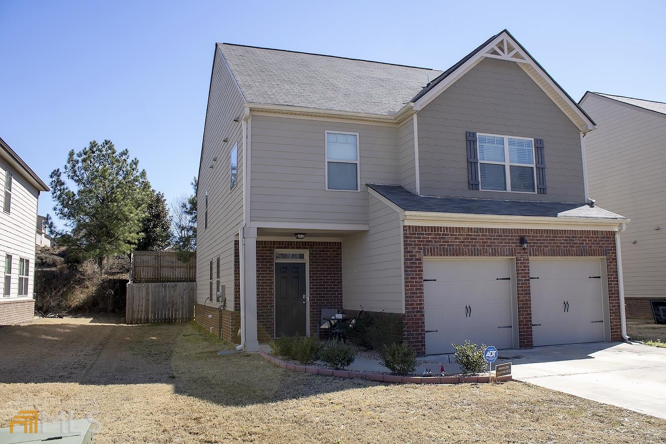 1072 Lear Drive Locust Grove, GA 30248 - Photo 1 of 1 a view of a house with a yard and garage