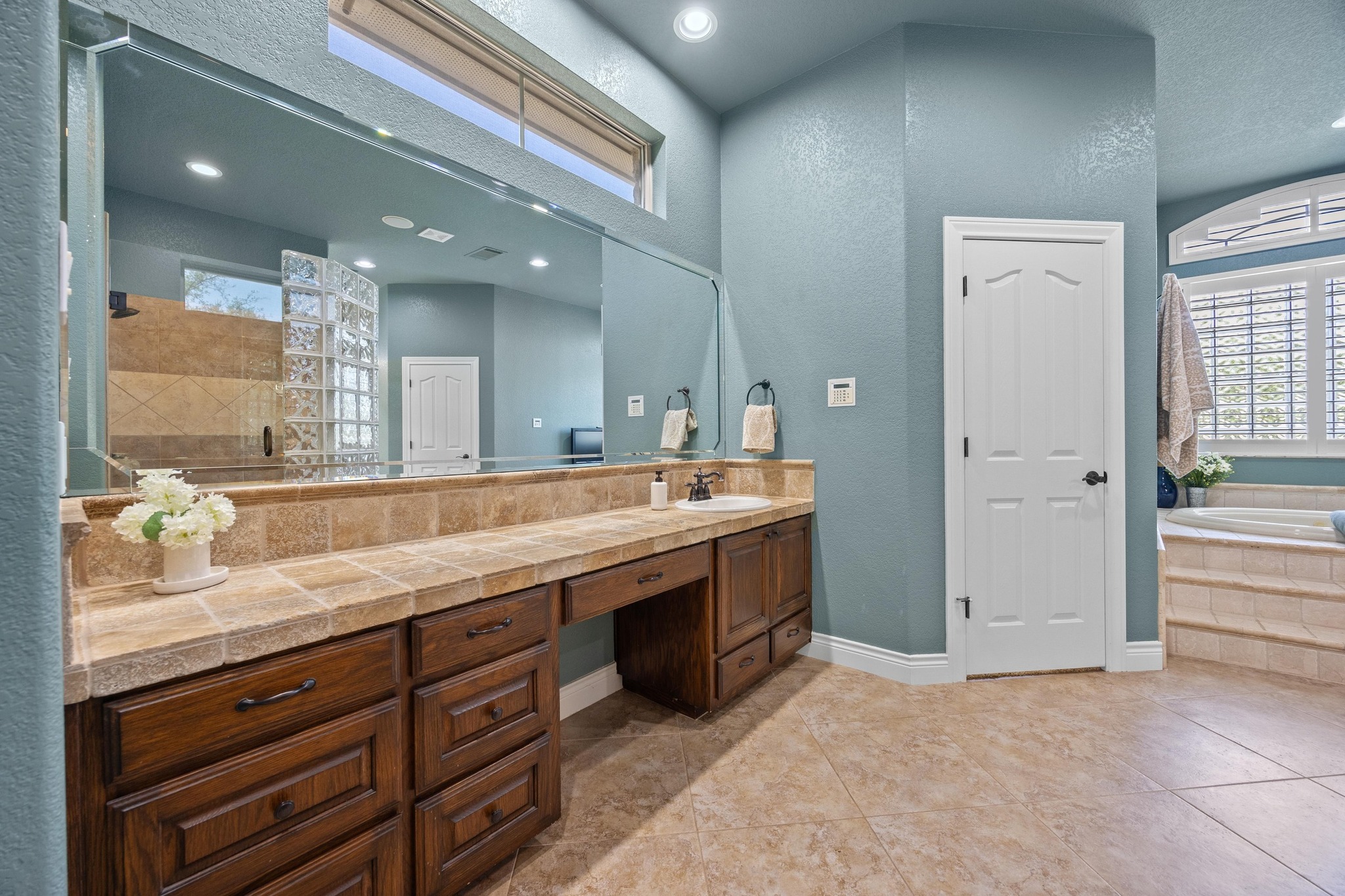 112 Shady Elm Georgetown, TX 78633 - Photo 14 of 31 a spacious bathroom with a granite countertop sink a mirror and a