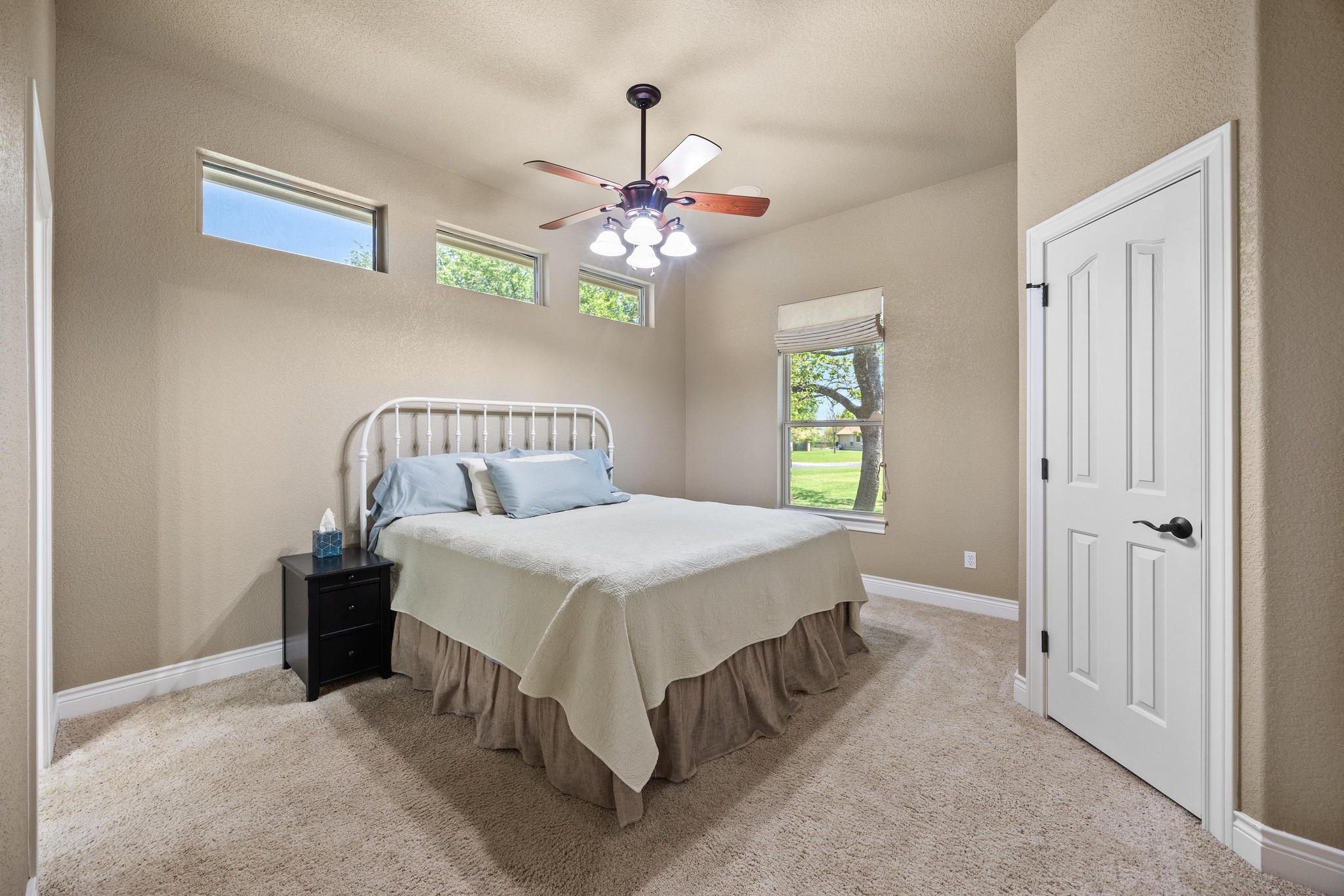 112 Shady Elm Georgetown, TX 78633 - Photo 21 of 31 a bedroom with a bed and a chandelier