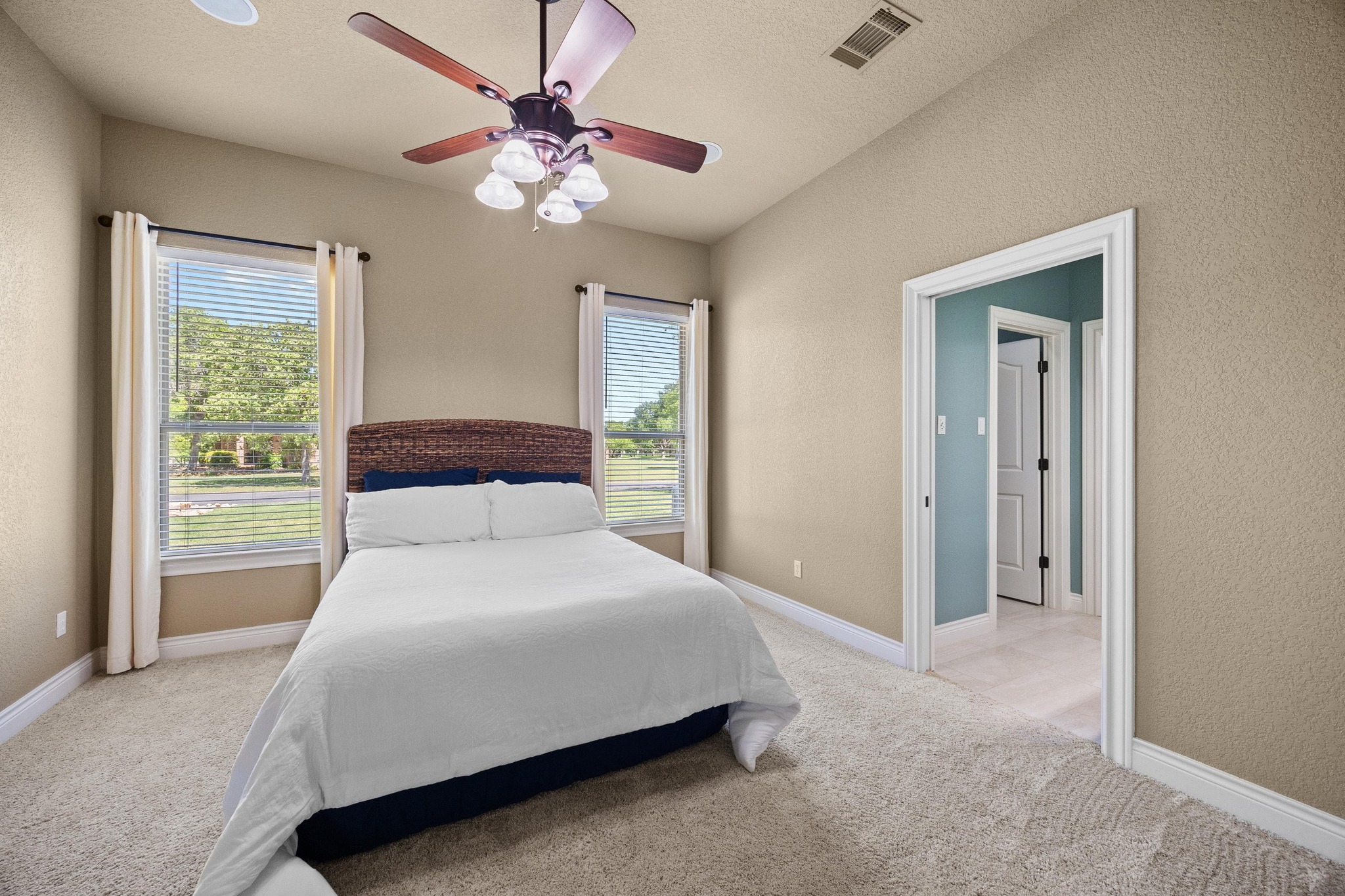 112 Shady Elm Georgetown, TX 78633 - Photo 22 of 31 a bedroom with a large bed and a chandelier