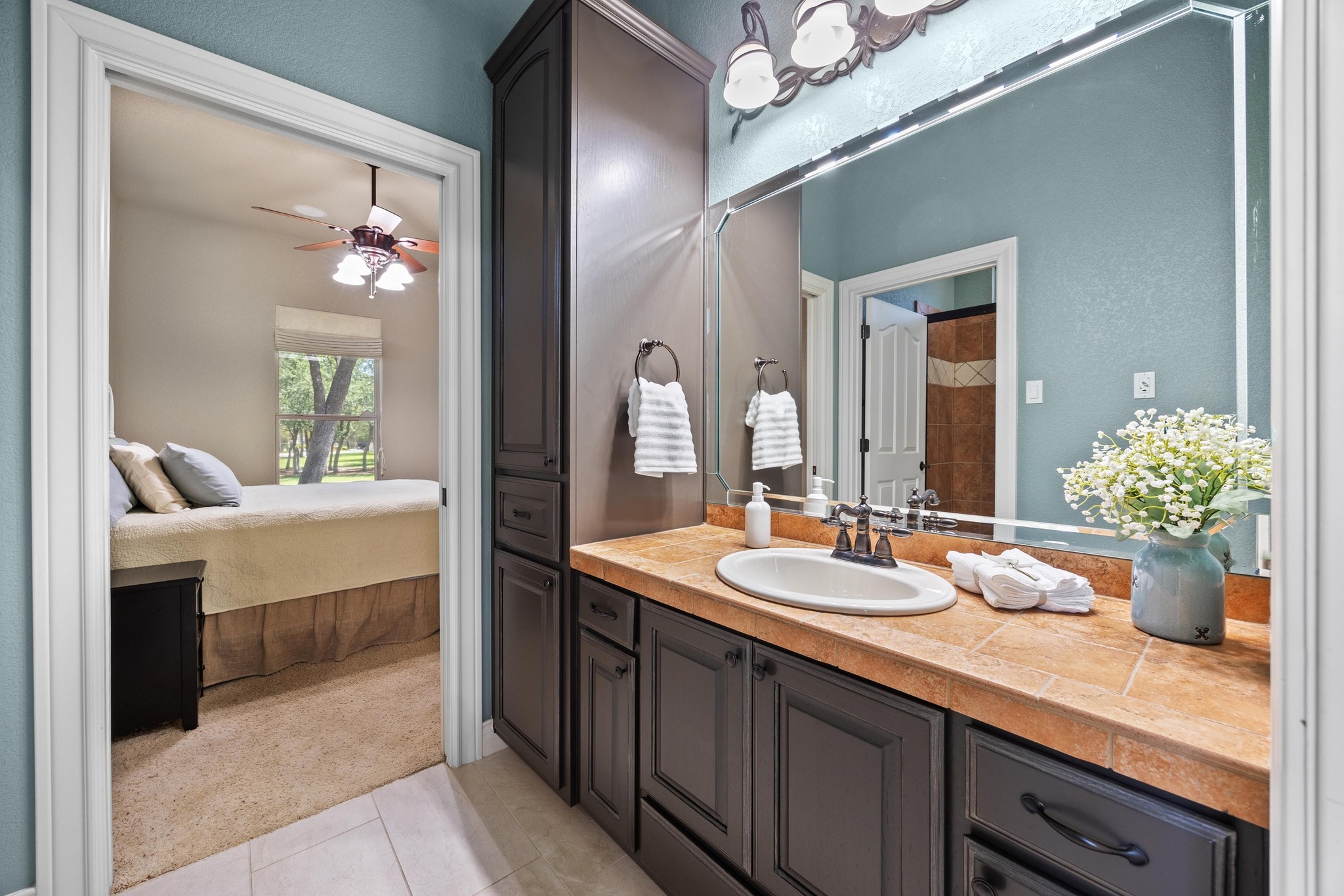 112 Shady Elm Georgetown, TX 78633 - Photo 23 of 31 a en suite bathroom with a granite countertop sink and a mirror