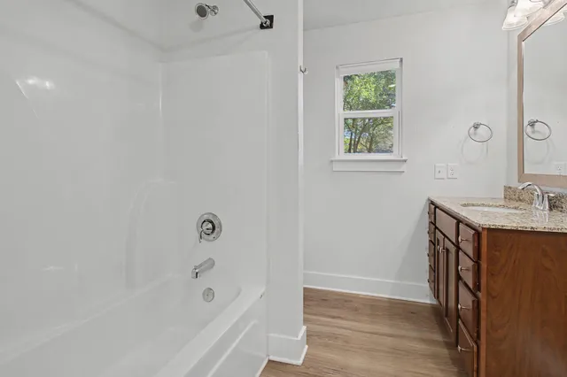 a bathroom with a bathtub and a sink