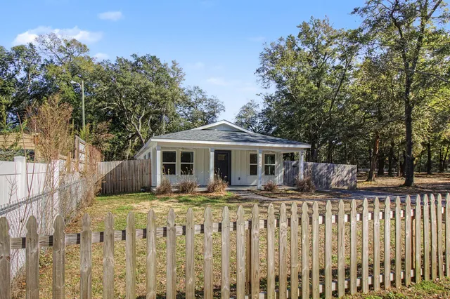 a front view of house with yard and trees