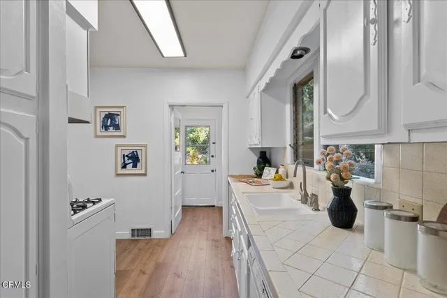 a kitchen with a sink cabinets and window