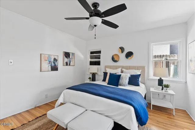 a bedroom with a bed and a potted plant