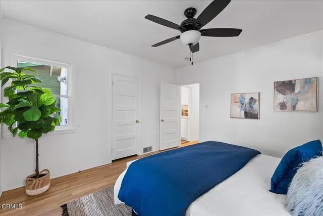 a bedroom with a bed and a potted plant