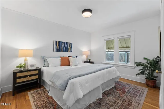 a bedroom with a bed and a potted plant