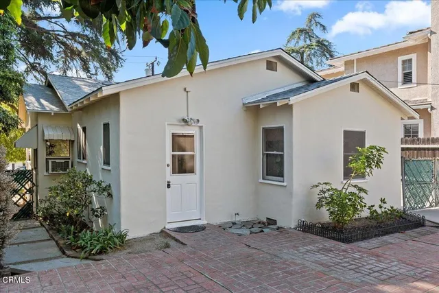 a couple of flower plants in front of house