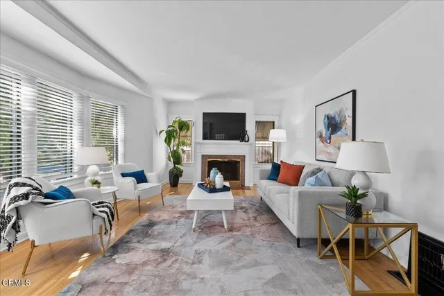 a living room with furniture a table and painting on the wall