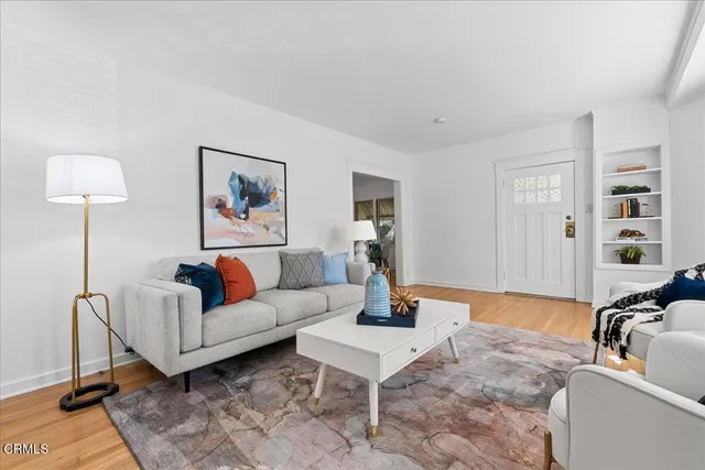 a living room with furniture potted plant and a window