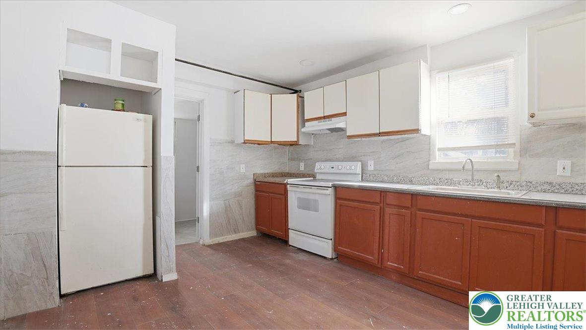 202 North Courtland Street, Unit 1 & 2 East Stroudsburg, PA 18301 - Photo 13 of 49 a kitchen with stainless steel appliances granite countertop a refrigerator sink and cabinets