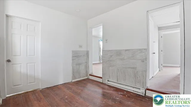 an empty room with wooden floor