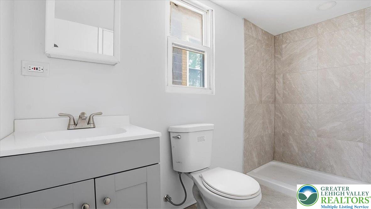 202 North Courtland Street, Unit 1 & 2 East Stroudsburg, PA 18301 - Photo 20 of 49 a bathroom with a sink a toilet and vanity