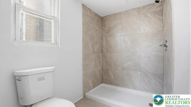 a bathroom with a toilet and bathtub