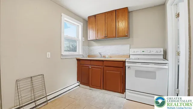 a kitchen with a stove cabinets and a refrigerator