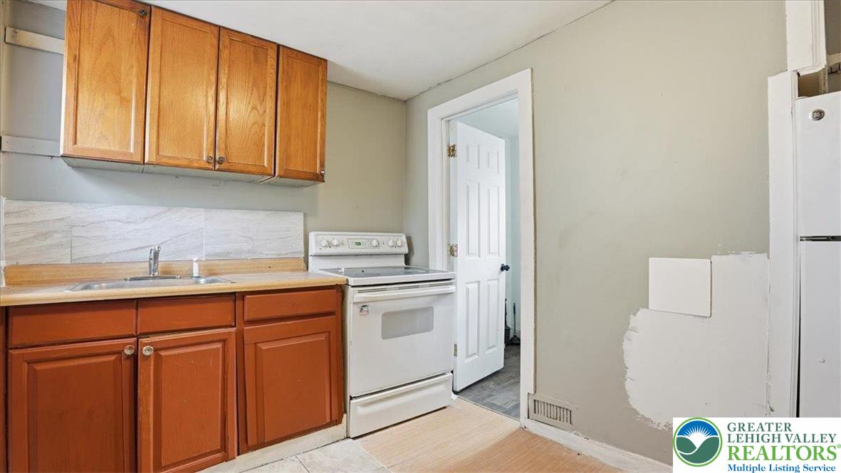202 North Courtland Street, Unit 1 & 2 East Stroudsburg, PA 18301 - Photo 28 of 49 a kitchen with a sink a stove and cabinets