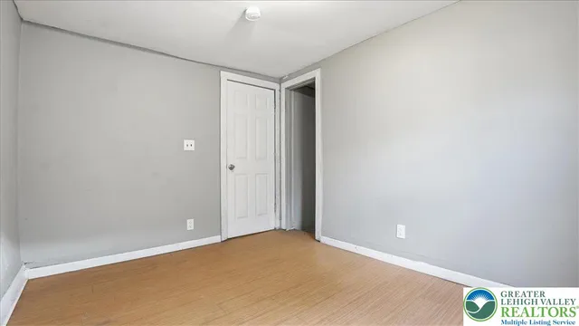 an empty room with wooden floor