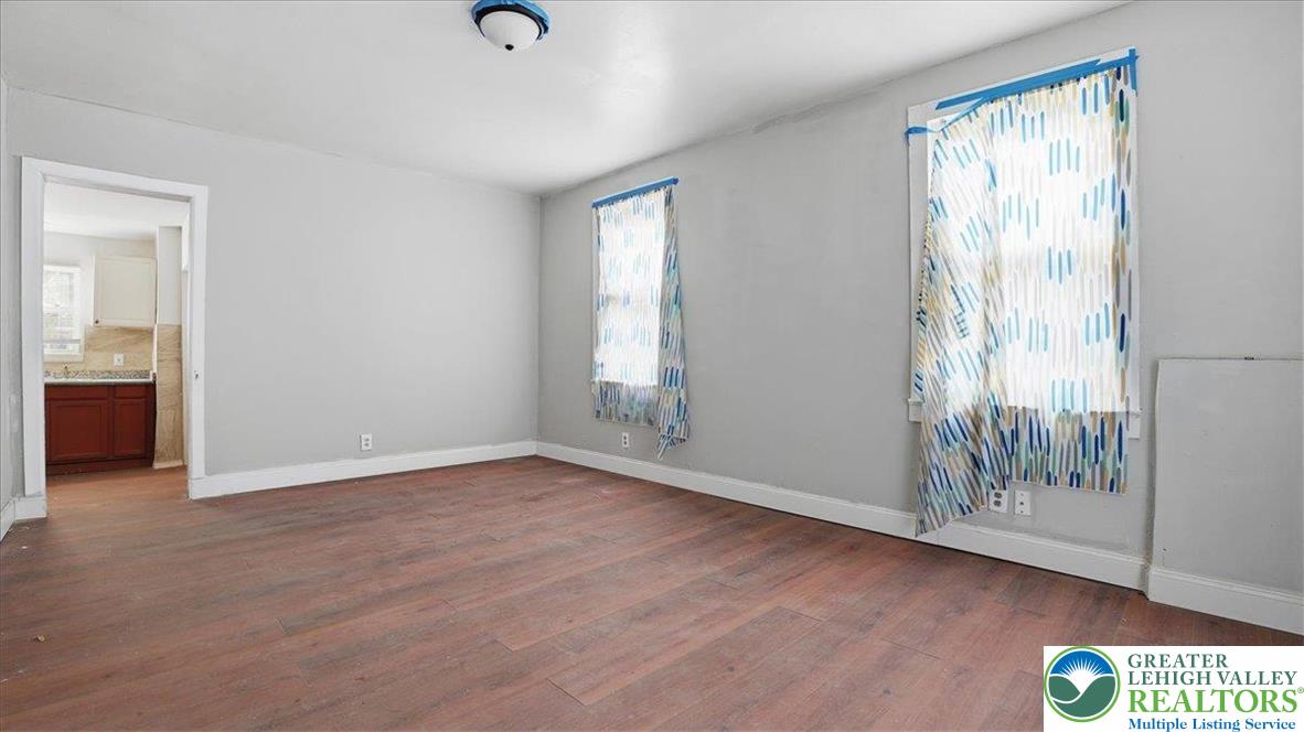202 North Courtland Street, Unit 1 & 2 East Stroudsburg, PA 18301 - Photo 7 of 49 a view of an empty room with wooden floor and a window