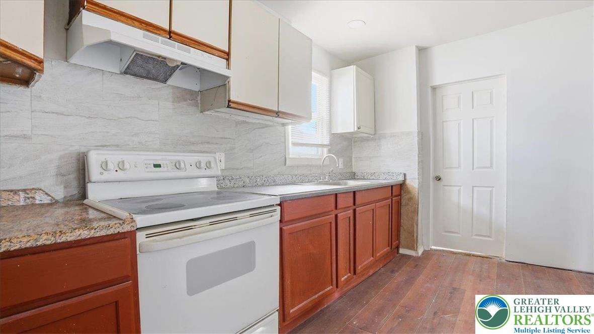 202 North Courtland Street, Unit 1 & 2 East Stroudsburg, PA 18301 - Photo 10 of 49 a kitchen with granite countertop a sink cabinets and wooden floor