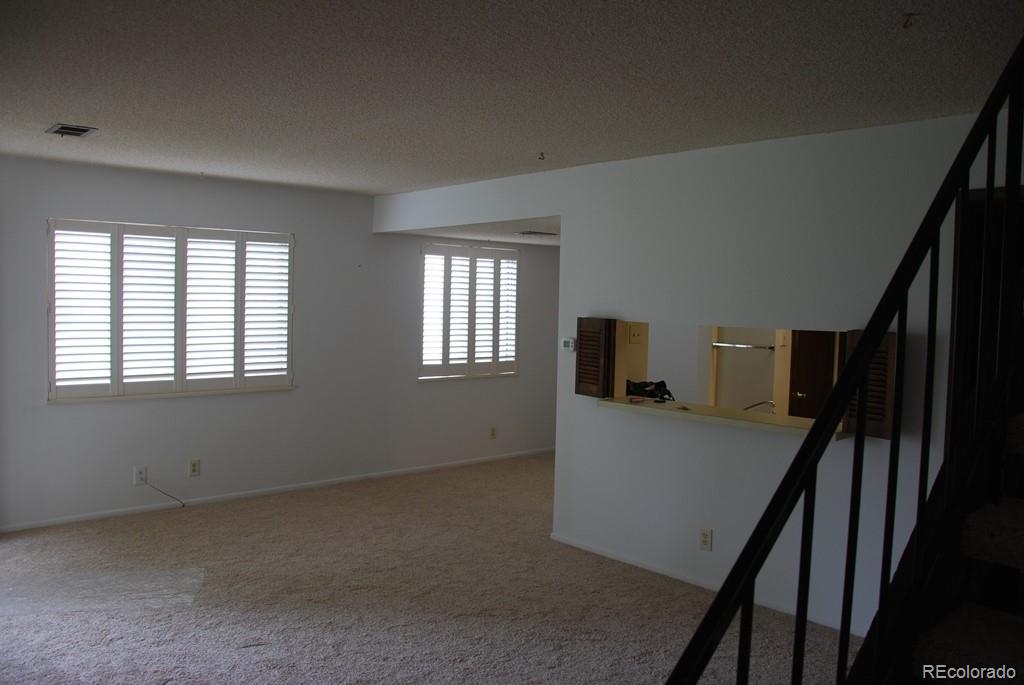 1225 South Oneida Street, Unit 226 Denver, CO 80224 - Photo 11 of 11 an entryway and livingroom with furniture