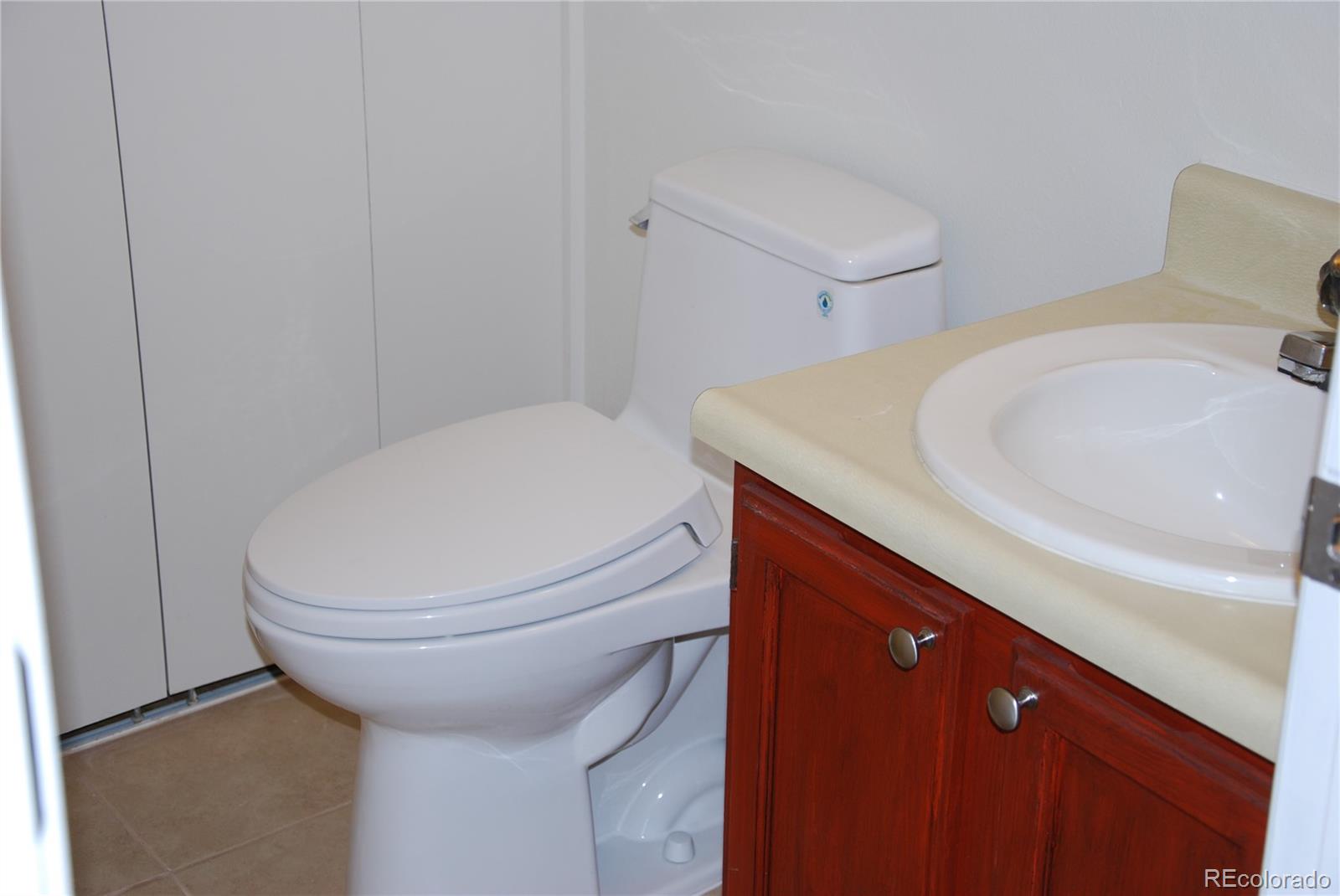 1225 South Oneida Street, Unit 226 Denver, CO 80224 - Photo 6 of 11 a bathroom with a sink and a toilet