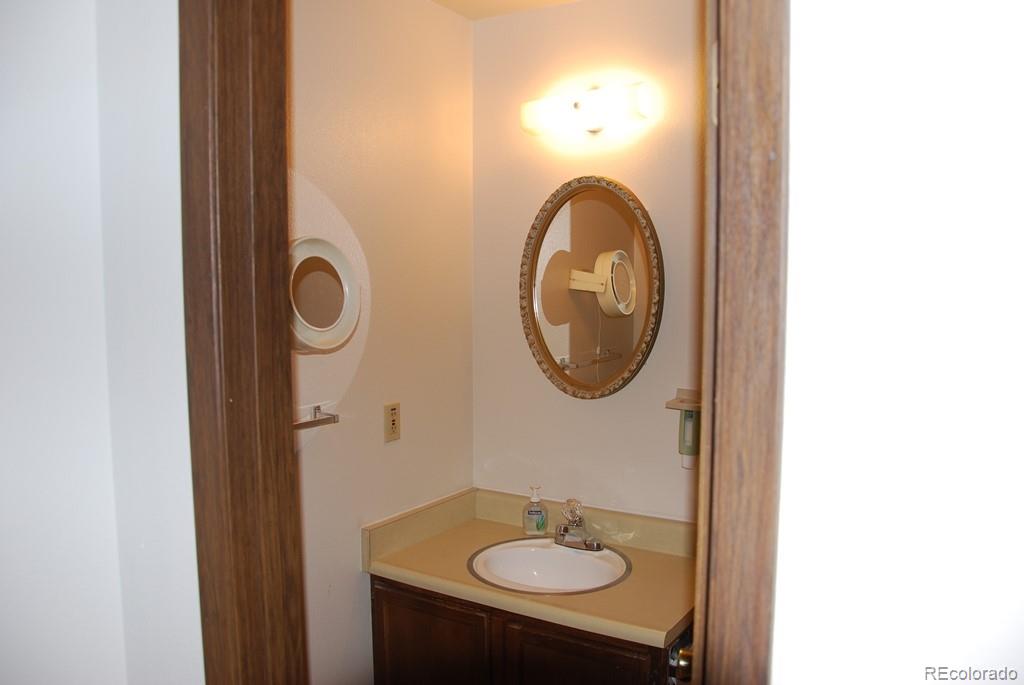 1225 South Oneida Street, Unit 226 Denver, CO 80224 - Photo 10 of 11 a bathroom with a sink and a mirror